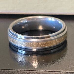 18K Two toned wedding band marked 18K  It is engraved with a name.